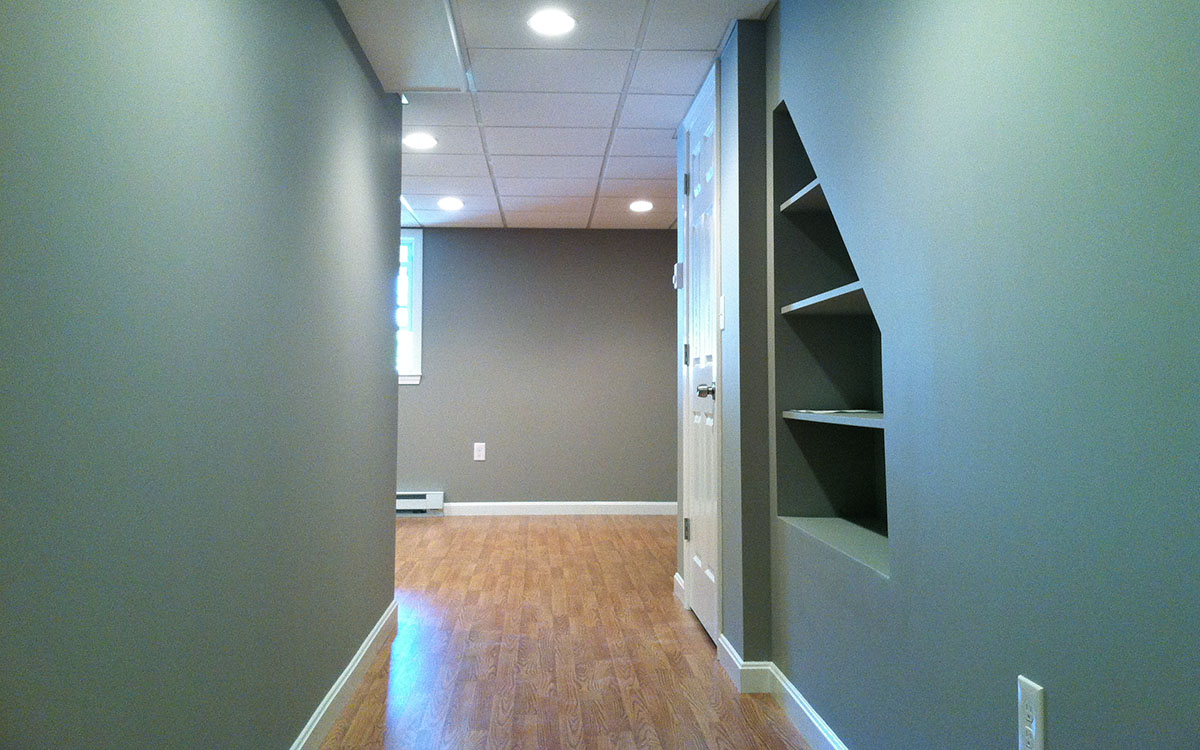 Basement finishing with built-in shelves under stairs. Arlington, MA 02474