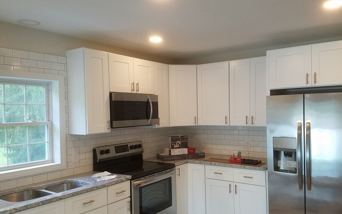 Major kitchen remodel. Included removing walls, new white cabinets, granite countertops, subway tile backsplash, new appliances. Millville, MA 01529.