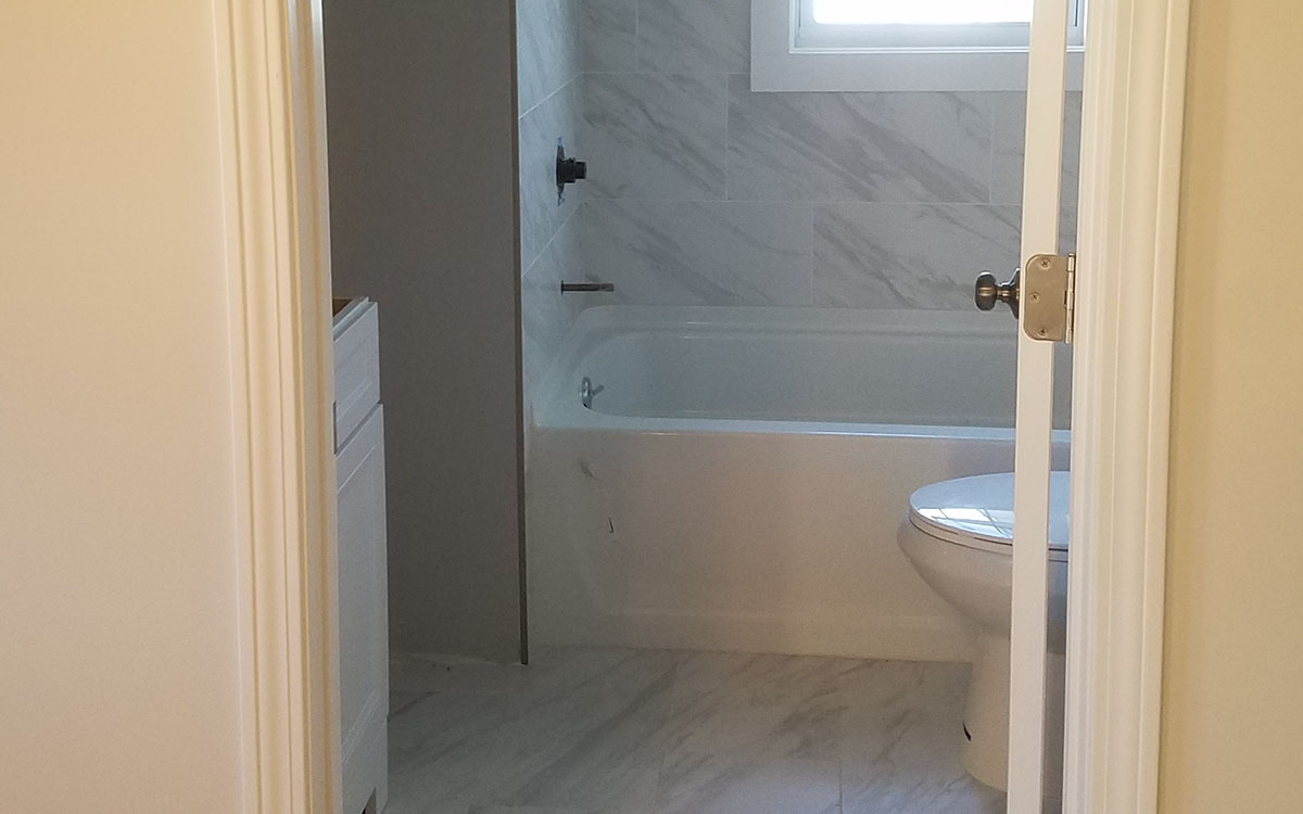 Complete bathroom remodel. Included new layout, moving walls, tile walls and floor, vanity, toilet, bathtub and shower, closet. Milllville, MA 01529.