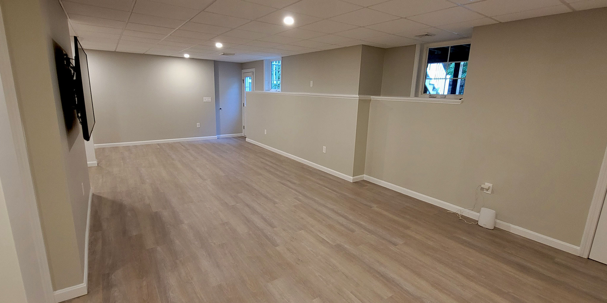 Franklin Massachusetts remodeled basement. Shaw Anvil LVP flooring, Armstrong 2x2 ceiling tiles with LED recessed lights.