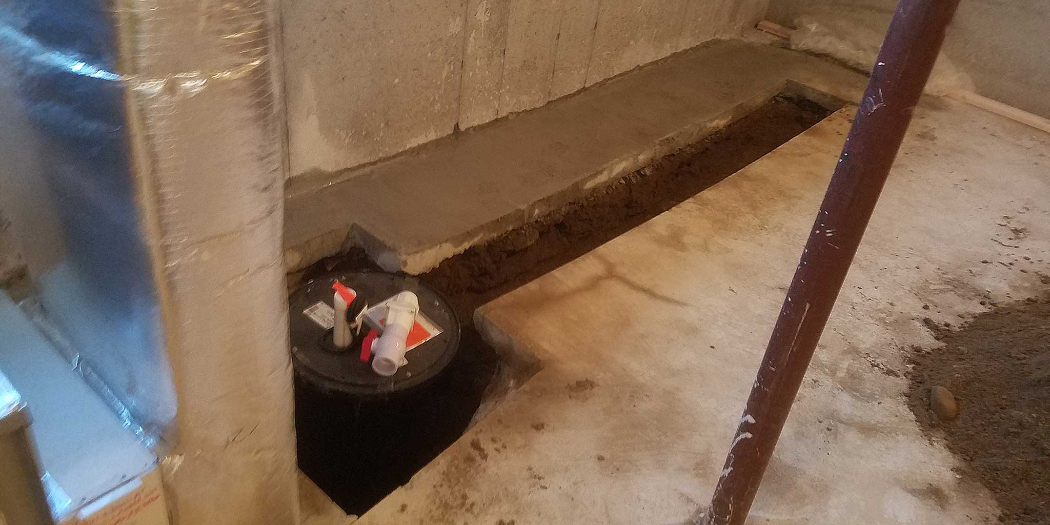 Because a new bathroom was being added, we had to remove some of the existing concrete floor in order to add a sewage ejector pump and below grade drain piping.